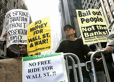 Demonstrators stand outside the New York Stock Exchange during a protest, while U.S. lawmakers met to vote on a $700 billion bailout of the financial industry, in New York September 29, 2008